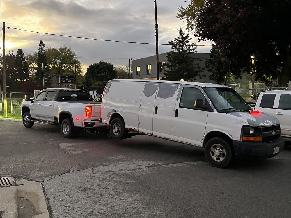 Bishopgate truck towing a van at dusk