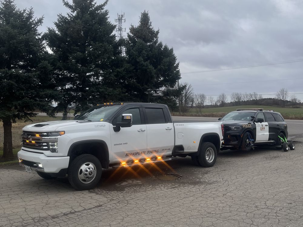 Bishopgate truck towing an Ontario Provincial Police cruiser